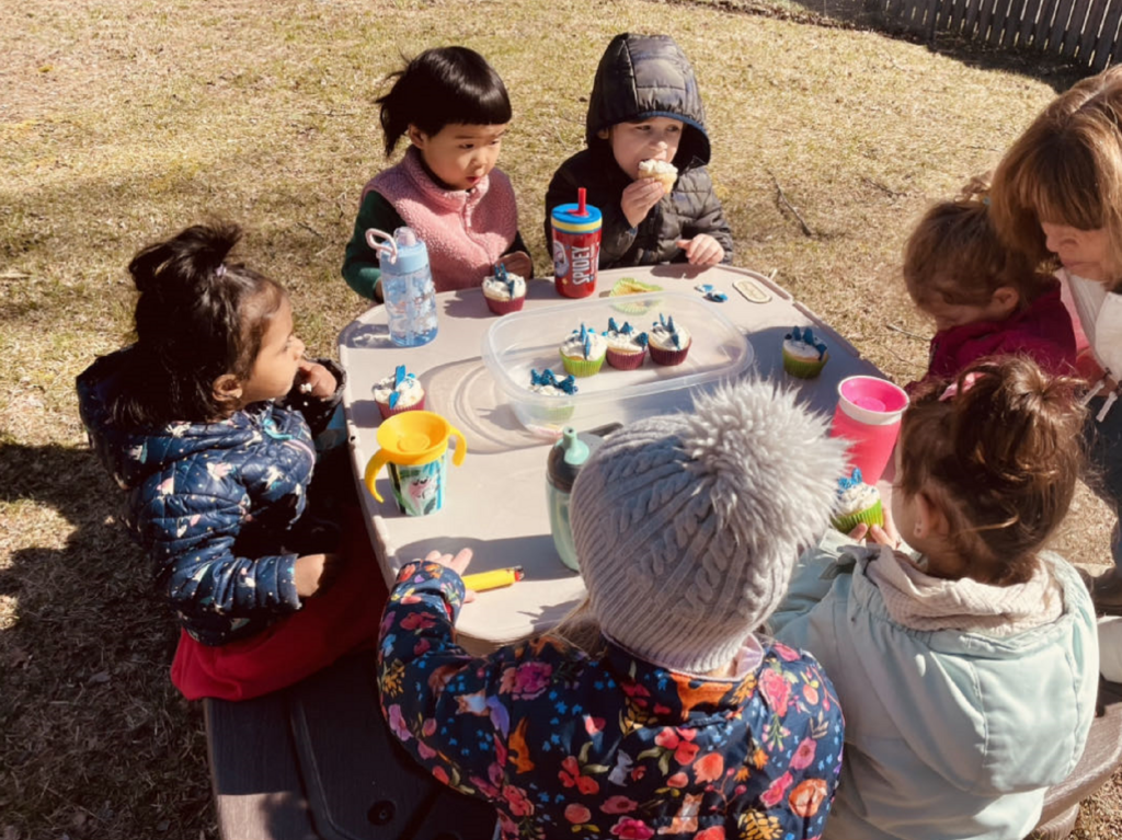 Kids eating snack outside.